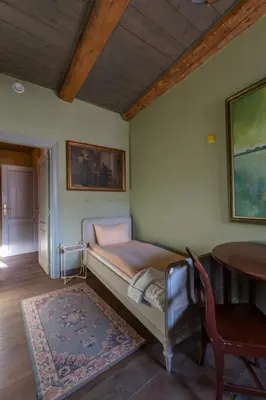 a bedroom with a bed and a table and a table at Uzupis Angel 3 bedroom Apartment in Vilnius