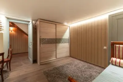 a room with a bed and a sliding glass door at Uzupis Angel 3 bedroom Apartment in Vilnius