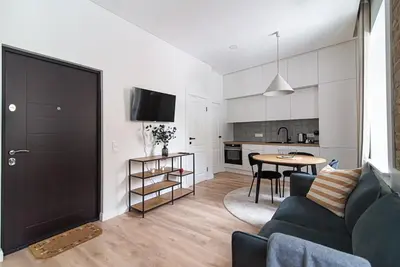a living room with a couch and a table at New and modern apartment in Old Town by URBAN RENT in Vilnius