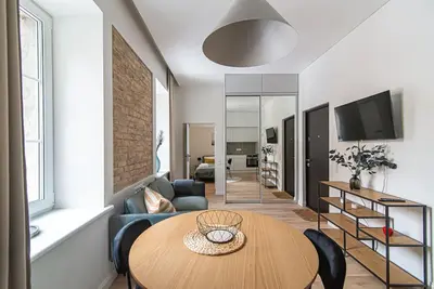 a living room with a table and a couch at New and modern apartment in Old Town by URBAN RENT in Vilnius