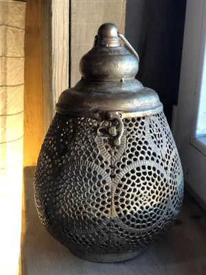 a large vase sitting on a table next to a window at Liepų pirtis in Smailiai