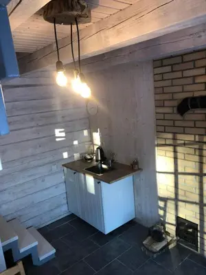 a kitchen with a sink in a room at Liepų pirtis in Smailiai