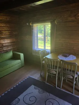 a room with a table and chairs and a couch at Šimtametis namelis in Anykščiai