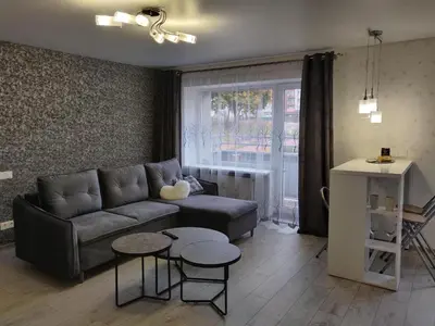 a living room with a couch and a table at Central cozy apartment in Kėdainiai