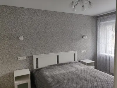 a bedroom with a bed and two night stands at Central cozy apartment in Kėdainiai