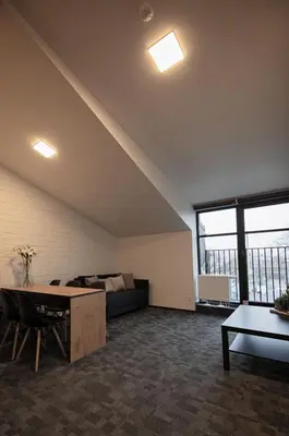 a living room with a couch and a table at LOFT INN Vilnius in Vilnius