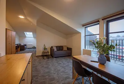 a large living room with a couch and a table at LOFT INN Vilnius in Vilnius