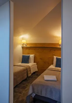 two beds in a room with two lamps at LOFT INN Vilnius in Vilnius