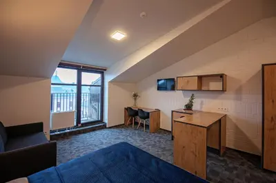 an attic room with a kitchen and a living room at LOFT INN Vilnius in Vilnius