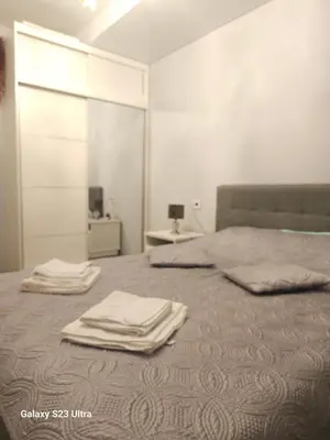 a bedroom with a bed with towels on it at Nemunaiciai in Kaunas