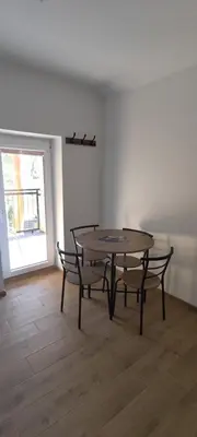 a dining room with a table and two chairs at Radikiai House in Smiltynai