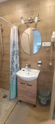a bathroom with a sink and a mirror at Radikiai House in Smiltynai