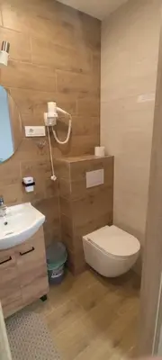 a bathroom with a toilet and a sink at Radikiai House in Smiltynai