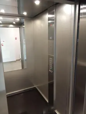 a bathroom with a walk in shower next to a mirror at Apartments with a balcony and an impressive terrace on the roof of the house in Vilnius