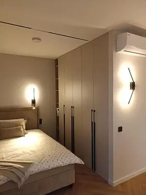 a bedroom with a bed and a white cabinet at Apartments with a balcony and an impressive terrace on the roof of the house in Vilnius