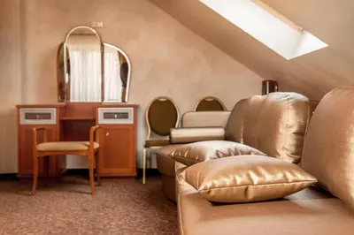 a dressing room with a mirror and a couch at Patalpų nuoma Žasliuose in Žasliai
