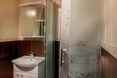a small bathroom with a sink and a shower at Patalpų nuoma Žasliuose in Žasliai