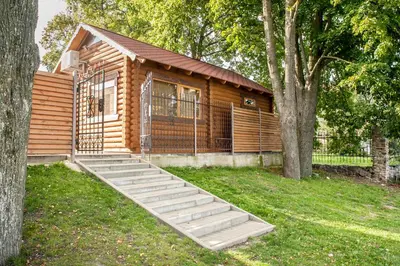 a log cabin with stairs leading to a building at Patalpų nuoma Žasliuose in Žasliai