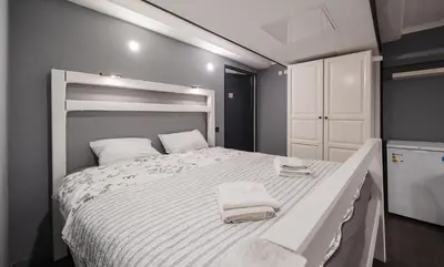 a bedroom with a large bed with towels on it at Islandijos Self Check-In Basement Apartments in Vilnius