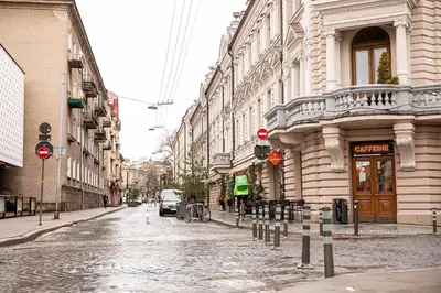 an empty street in a city with buildings at Islandijos Self Check-In Basement Apartments in Vilnius