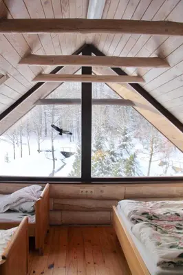 a room with two beds and a large window at Kaimo sodyba Dešimt Beržų in Gudžioniai