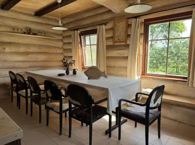 a dining room with a table and chairs at Kaimo sodyba Dešimt Beržų in Gudžioniai