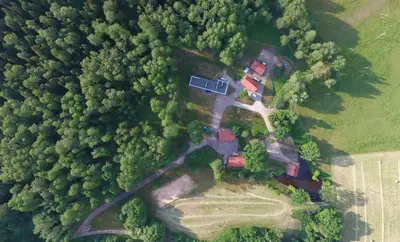 an aerial view of a house in the forest at Kaimo sodyba Dešimt Beržų in Gudžioniai