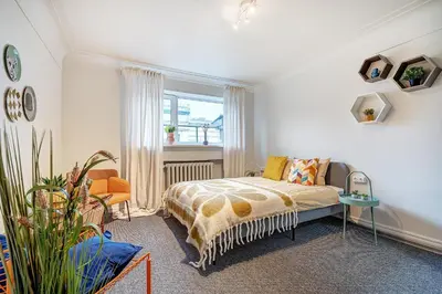 a bedroom with a bed and a window at Funky Penthouse City Center in Kaunas