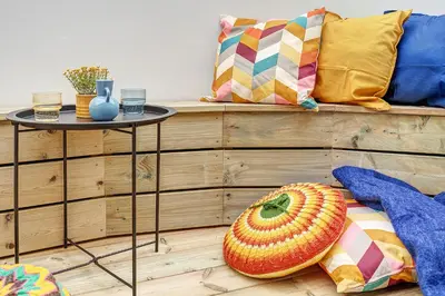 a living room with a table and a couch at Funky Penthouse City Center in Kaunas