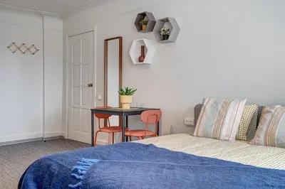 a bedroom with a bed and a table with chairs at Funky Penthouse City Center in Kaunas