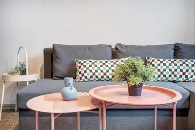 a living room with two tables and a couch at Funky Penthouse City Center in Kaunas