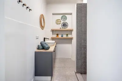 a bathroom with a sink and a counter in a room at Funky Penthouse City Center in Kaunas