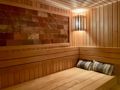 a sauna with a bench in the middle at Apartamentai Ornamentai in Druskininkai
