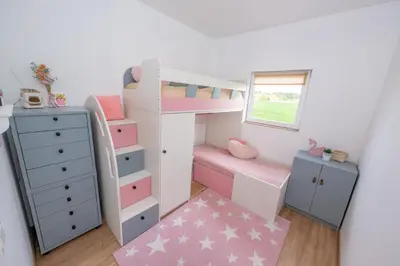 a childs bedroom with a bunk bed and a dresser at Poilsio oazė in Vynupė