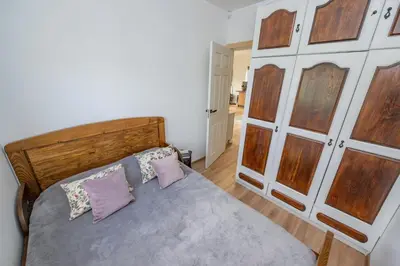 a bedroom with a wooden bed with two pillows at Poilsio oazė in Vynupė