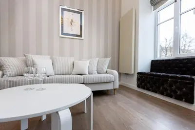 a living room with a couch and a table at Center Avenue Apartments in Vilnius