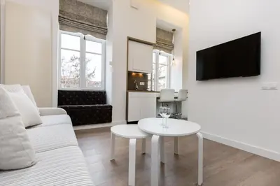 a living room with a white couch and a table at Center Avenue Apartments in Vilnius