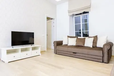 a living room with a couch and a flat screen tv at Center Avenue Apartments in Vilnius