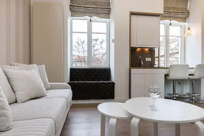 a living room with a white couch and a table at Center Avenue Apartments in Vilnius