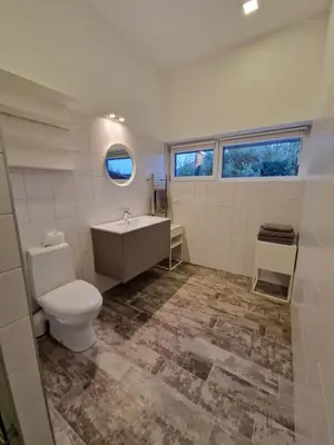a bathroom with a toilet and a sink at IG House in Druskininkai