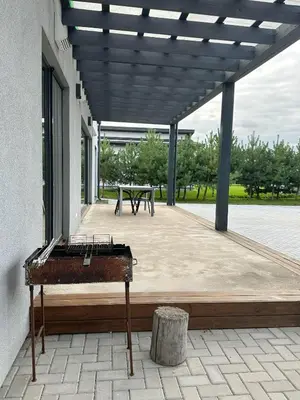 an outdoor patio with a table and a bench at IG House in Druskininkai