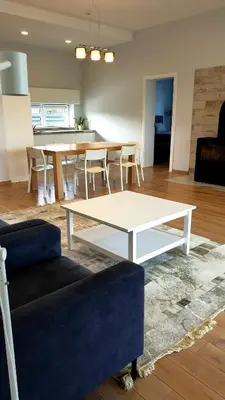 a living room with a couch and a table at IG House in Druskininkai