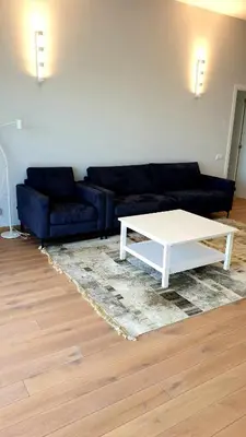 a living room with a couch and a coffee table at IG House in Druskininkai