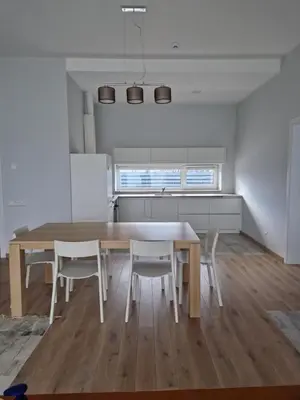 a kitchen and dining room with a table and chairs at IG House in Druskininkai