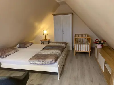 a bedroom with two beds in a attic at Lampėdis in Kaunas