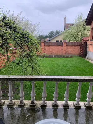 a white fence with a yard in the background at Lampėdis in Kaunas