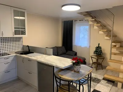 a kitchen and living room with a table and chairs at Lampėdis in Kaunas