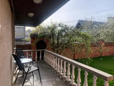 a balcony with two chairs and a table on it at Lampėdis in Kaunas