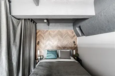 a bedroom with a large bed with blue pillows at Modern Urban loft in Vilnius