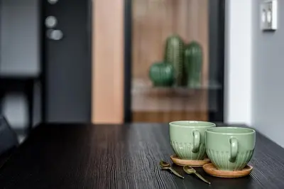 two green cups sitting on top of a table at Modern Urban loft in Vilnius